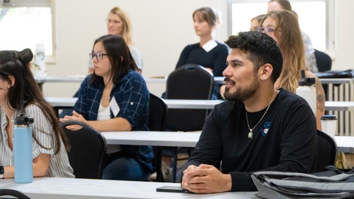 student listening and smiling in classroom