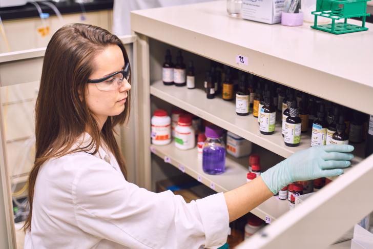 student looking at research materials in lab