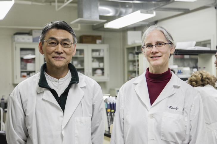 two researchers smiling